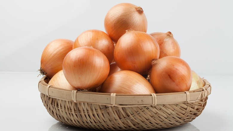 Yellow onions in a woven basket