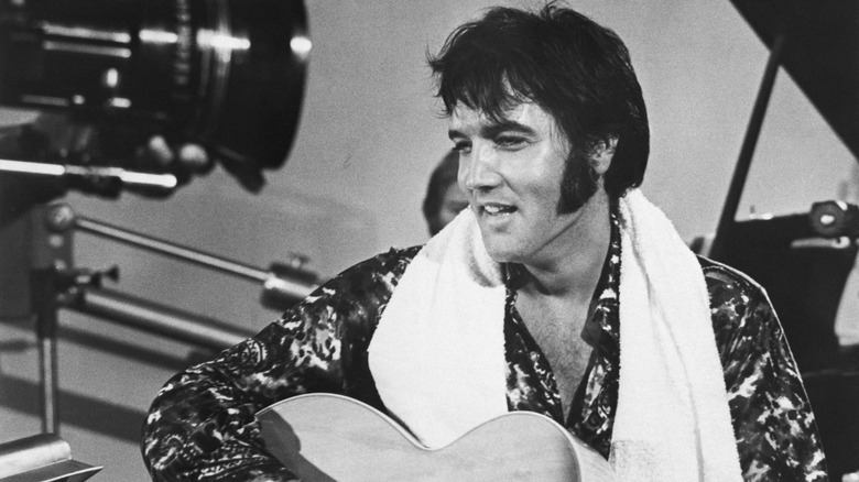 Elvis Presley plays guitar during a scene from the documentary film Elvis: That's the Way It Is.