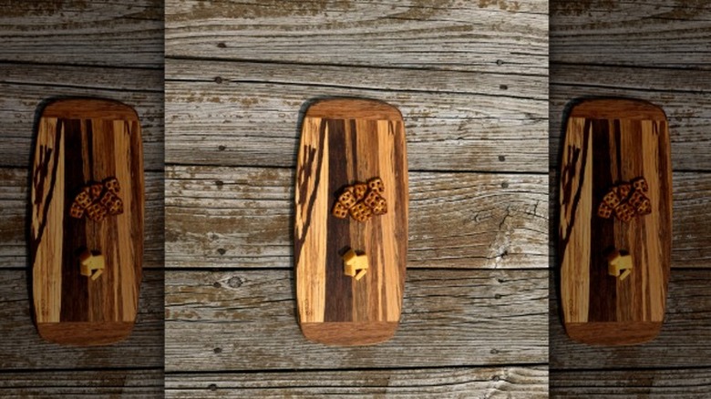 Cracker Barrel's gouda cheese with pretzels on a cutting board