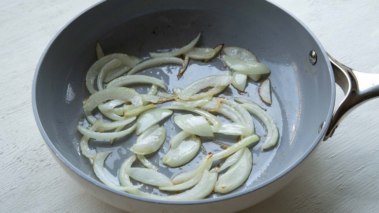 onions sauteeing in skillet