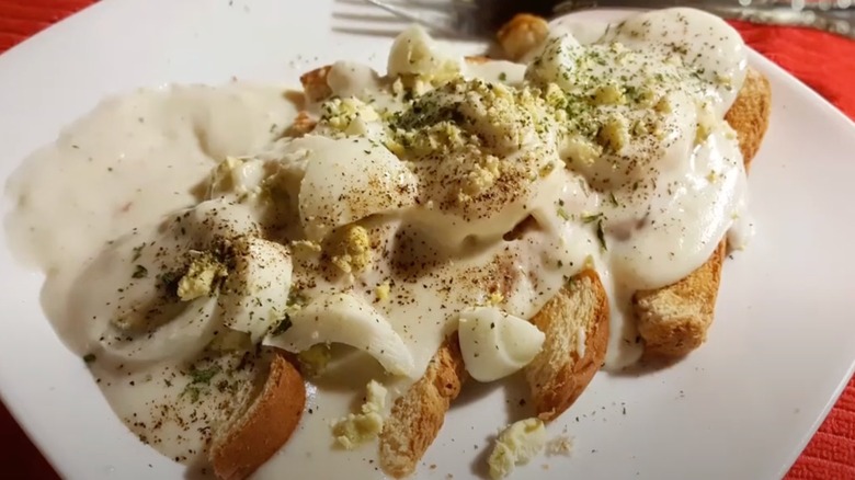 Eggs in white sauce on toast