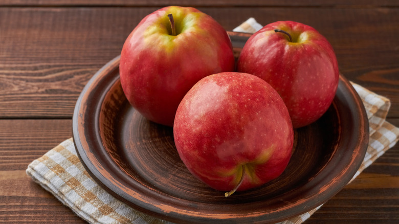 Pink Lady apples on a plate with a napkin