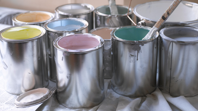Several open cans of paint