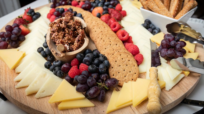 cheese play with crackers, fruit and mustard
