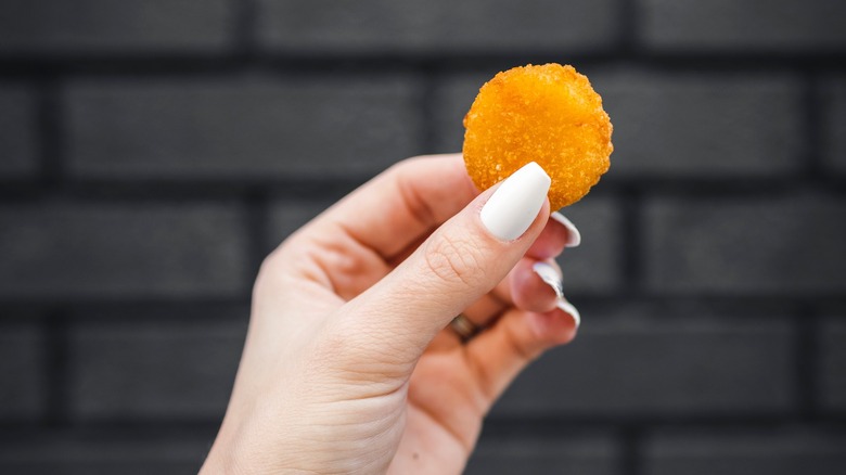 hand holding Cheddar Round