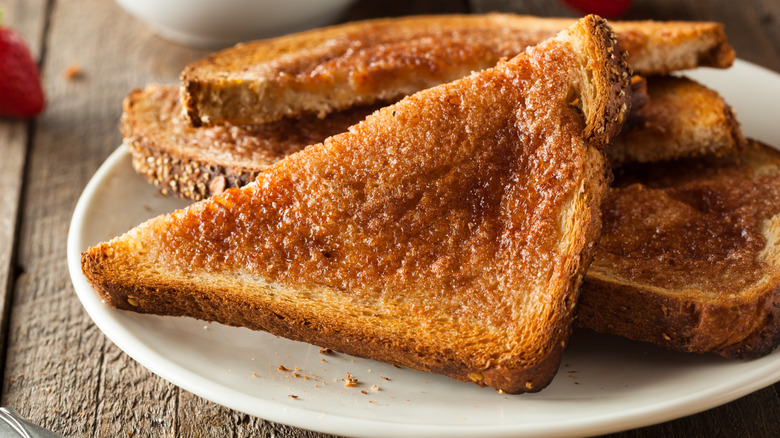 Sliced cinnamon toast on white plate