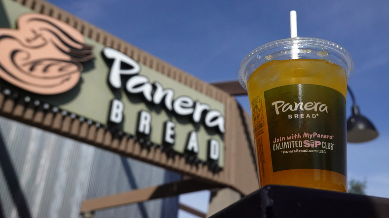cup of panera charged lemonade in front of panera bread location