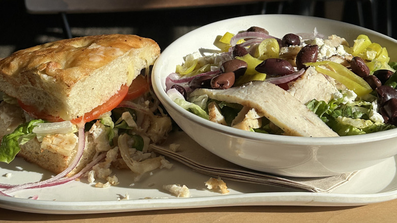 A salad and a sandwich from Panera Bread on a plate