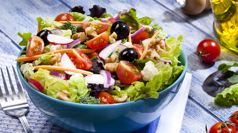 Fresh salad in a blue bowl