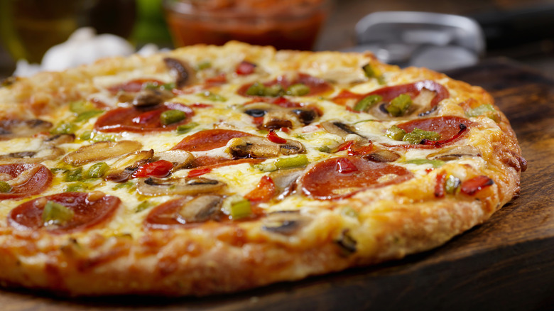 Homemade pizza with pepperoni, mushrooms, and peppers