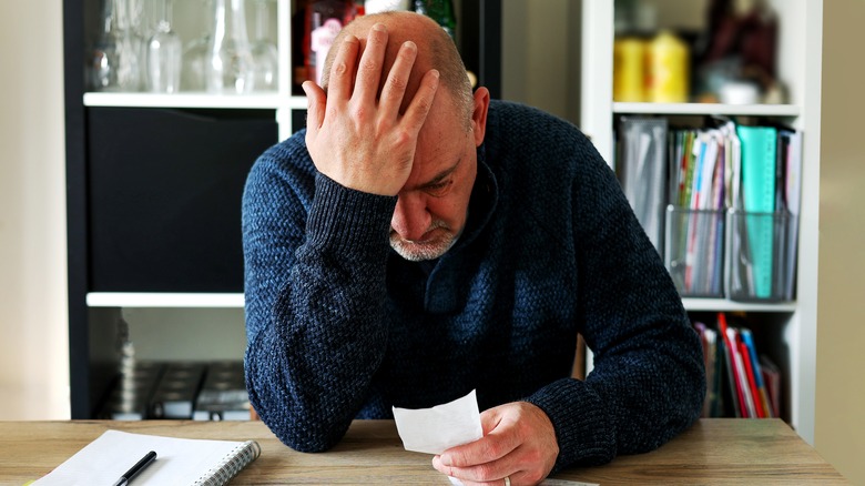 Man fuming over receipts