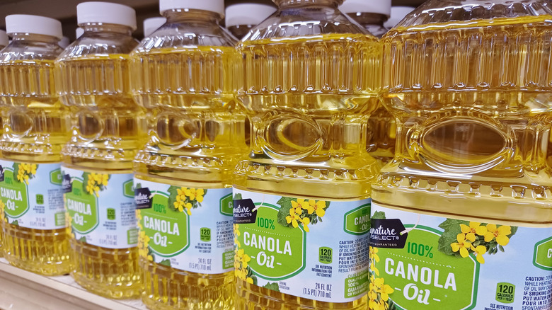 Bottles of canola oil on store shelf