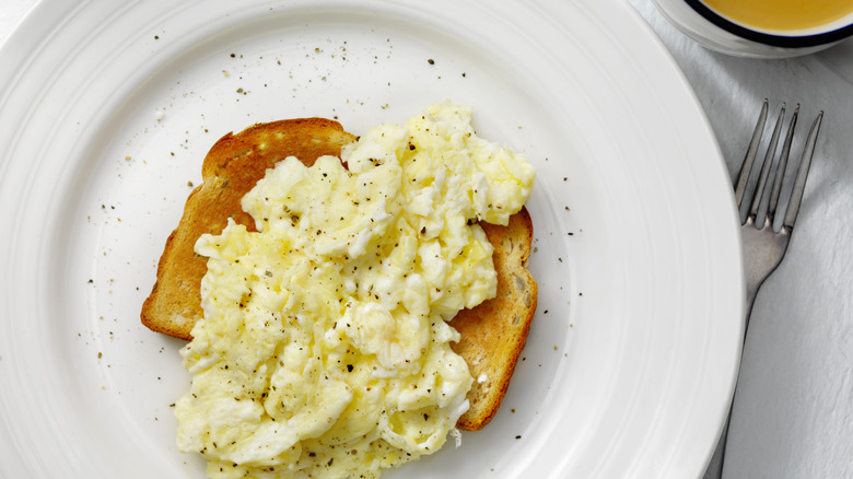 Seasoned scrambled eggs on a piece of toast