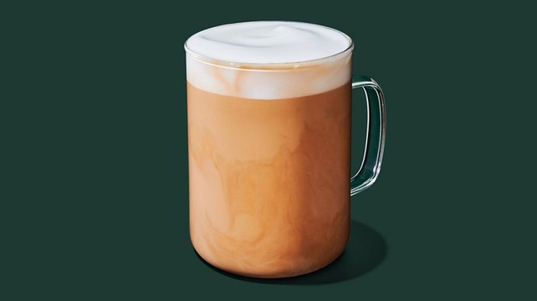 Starbucks Hot Vanilla Protein Latte in glass mug on dark green background