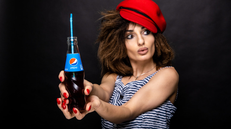 Woman holding pepsi bottle