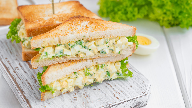 Egg salad sandwiches on cutting board