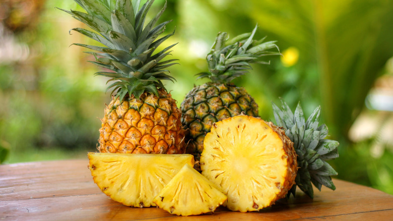 whole and sliced pineapples outdoors