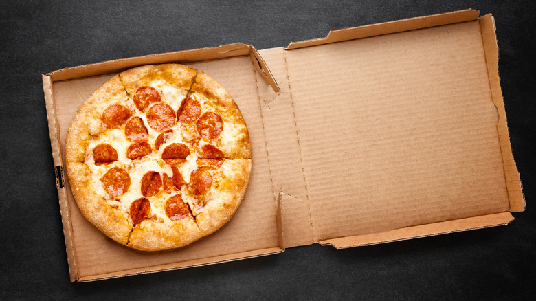 Pepperoni pizza in open cardboard box