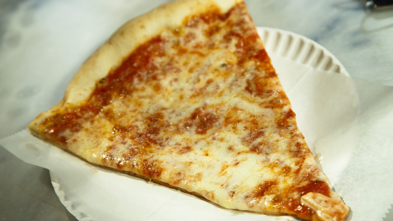 New York pizza slice on paper plate