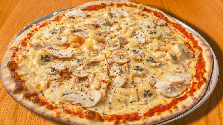 pizza with bananas, pineapple, and chicken