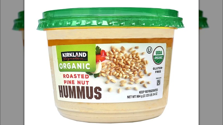 a tub of Kirkland Signature Organic Roasted Pine Nut Hummus