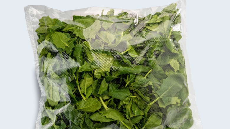 Salad greens in a sealed plastic bag