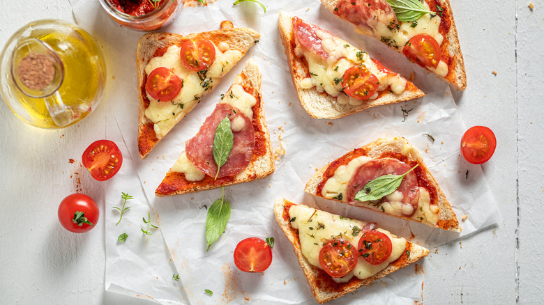 Slices of pizza toast on parchment paper