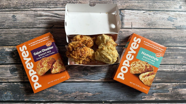 Popeyes Biscuit mix boxes and four biscuits in a box