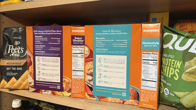 The back and side of Popeyes Biscuits mix boxes on a pantry shelf