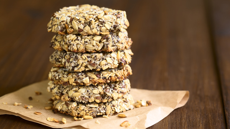 Stack of cookies coated in oats and seeds