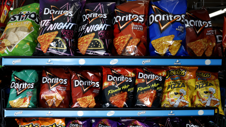 Various packages of Dorito's are displayed on supermarket shelves