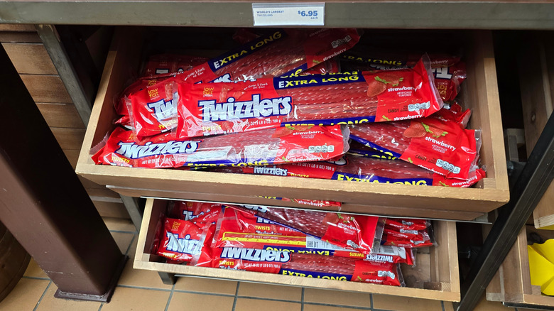 Packs of Twizzlers are displayed in supermarket bins
