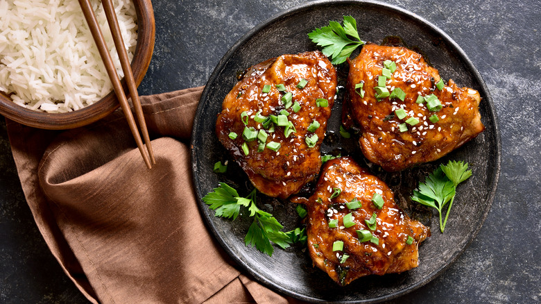 crispy chicken thighs topped with scallions