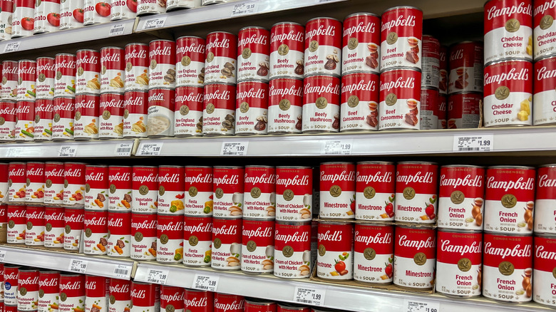 Several store shelves full of various flavors of Campbell's soups