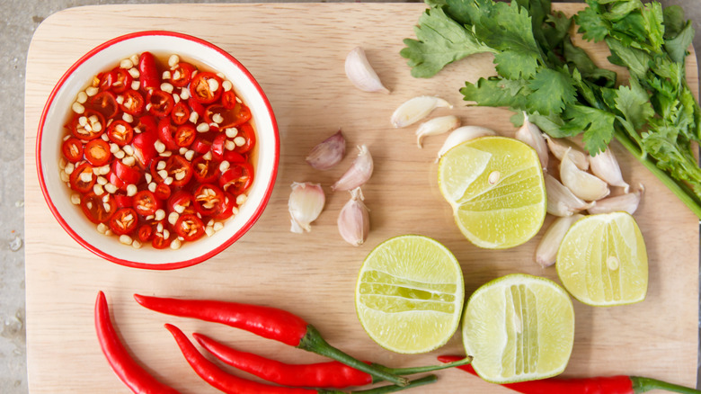 Prik nam pla with ingredients on cutting board