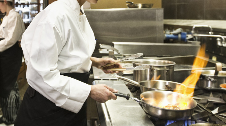 professional chefs cooking in restaurant kitchen