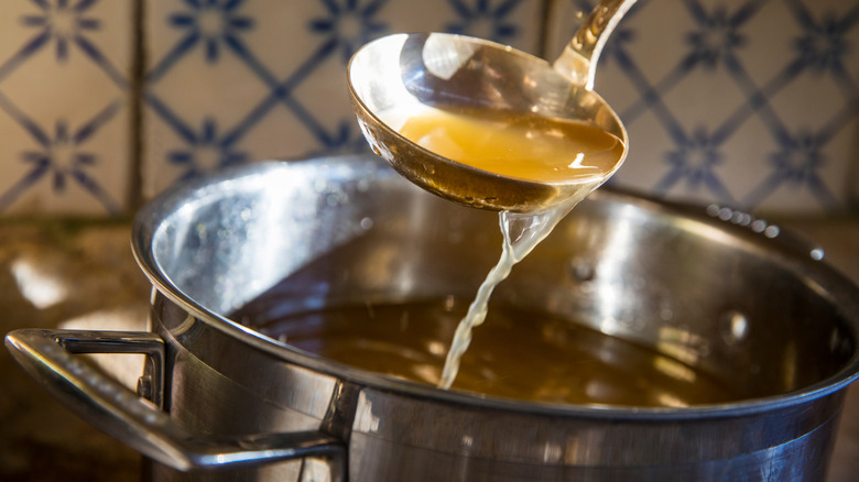 Stock in a pot with ladle