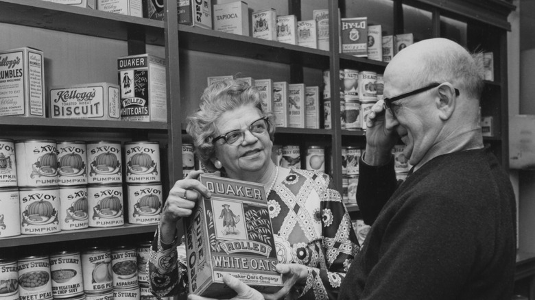 Couple looking at Quaker products in black & white image