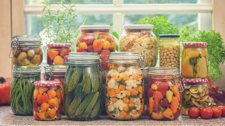 Pickled carrots, green beans, and other vegetables in jars