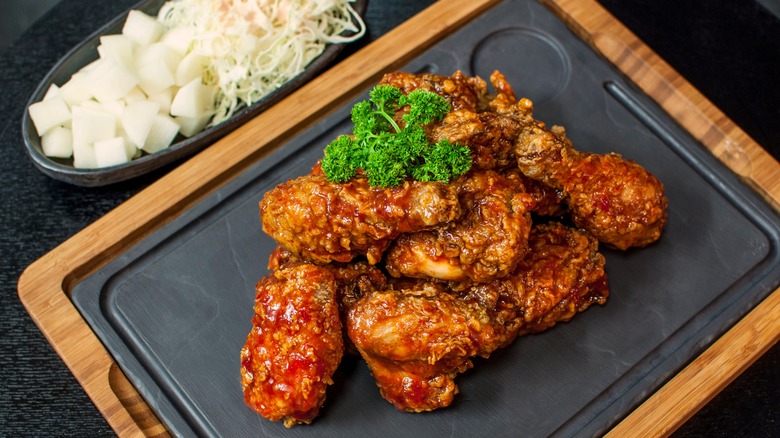 Korean fried chicken on a black and brown tray