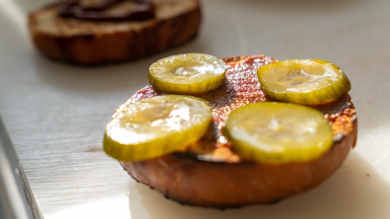sliced Pickles on burger patty