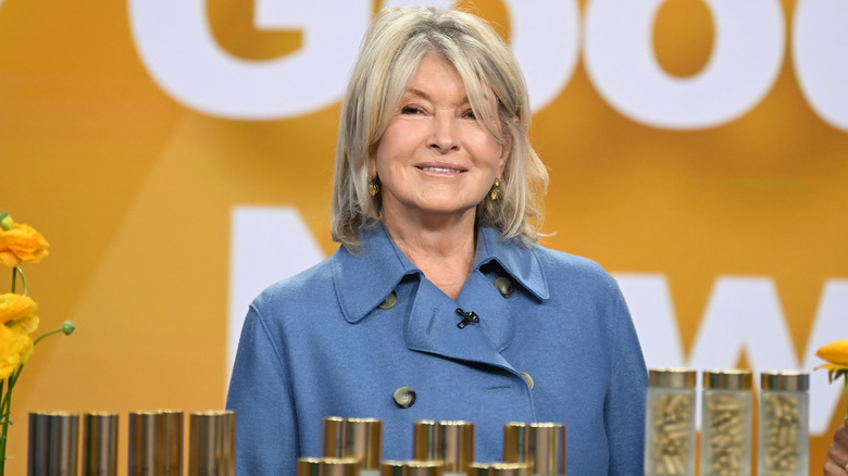 Martha Stewart smiling in front of yellow background