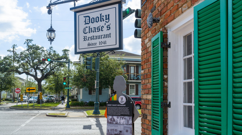 Sign outside of Dooky Chase which has green shutters