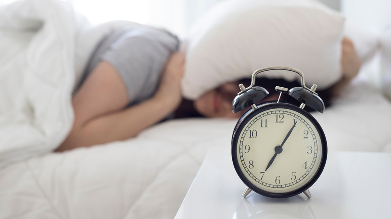 women covering head with pillow