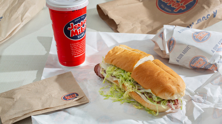 A Jersey Mike's sub and soda on a table