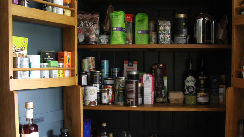 An open pantry area with items arranged on shelves