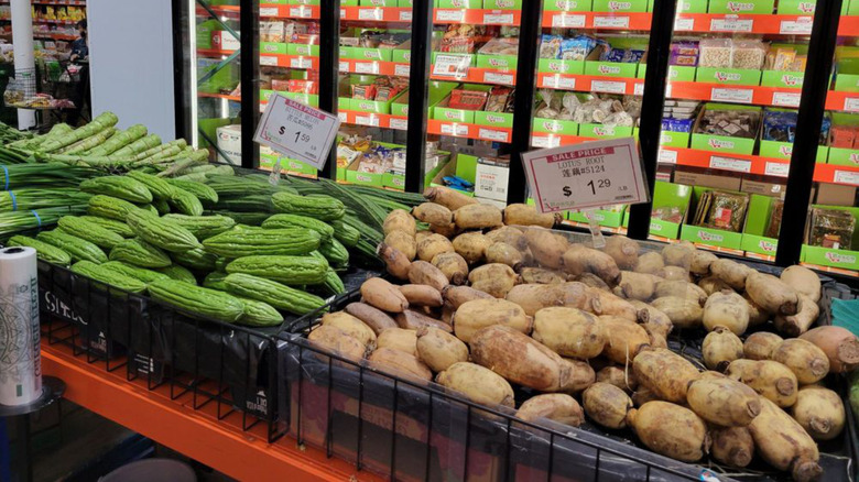 Produce bins full of lotus root and bitter melon