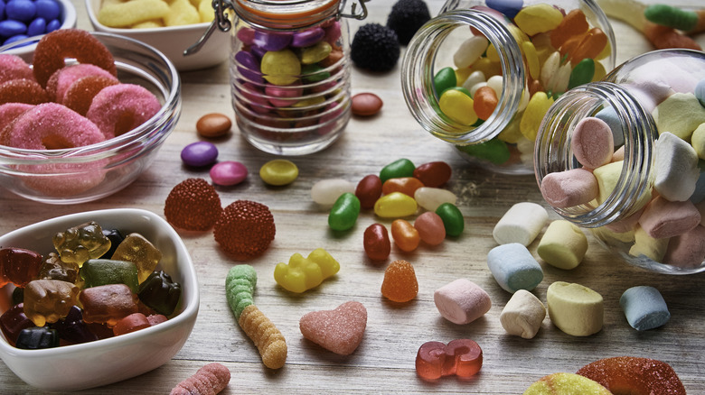 Variety of candy types in bowls and jars