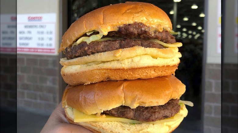 Two Costco cheeseburgers stacked on top of each other