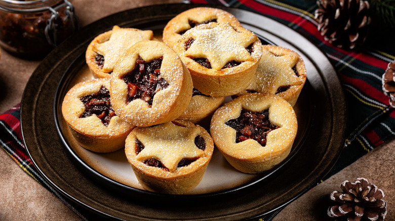 A plate full of mincemeat pies on a table
